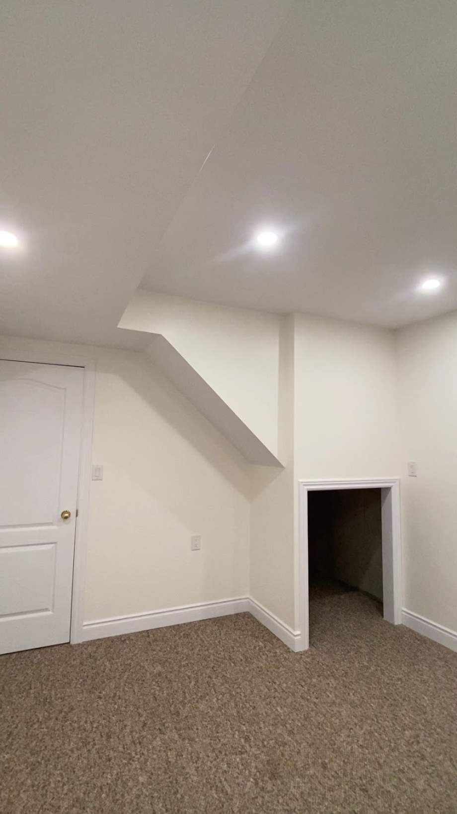 Finished basement by Putty Pros — smooth painted walls, pot lights and trim in Burlington